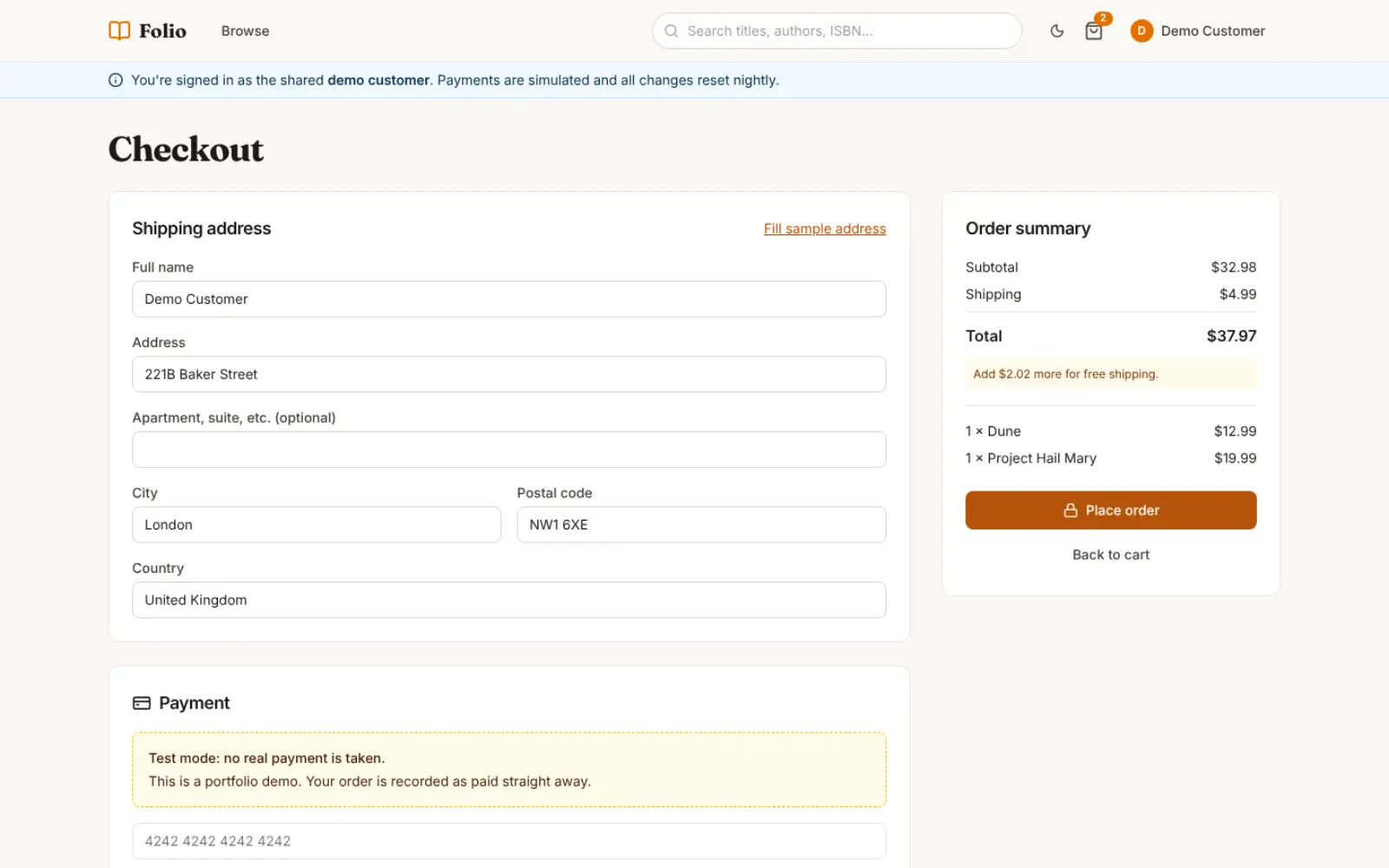 Folio's checkout as the demo customer: a shipping form, an order summary with two books, and a test-mode payment notice